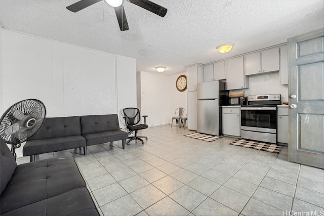 kitchen with appliances with stainless steel finishes, a textured ceiling, and ceiling fan