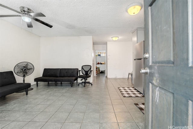 interior space with ceiling fan and a textured ceiling