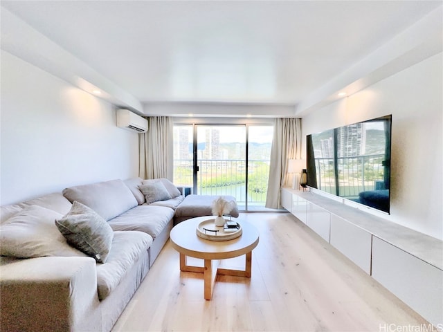 living room with light wood-type flooring and a wall unit AC