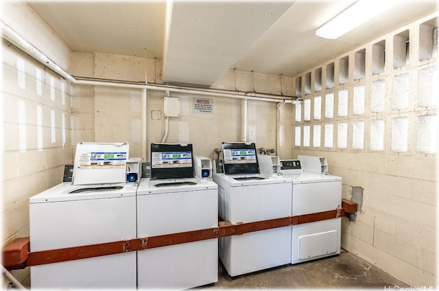 clothes washing area with washer and clothes dryer