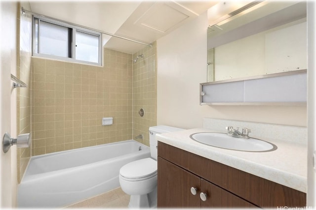 full bathroom with toilet, tiled shower / bath, vanity, and tile patterned flooring