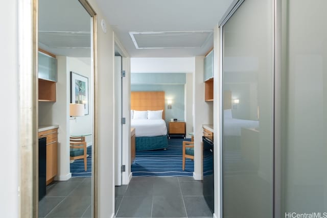 corridor featuring dark tile patterned floors