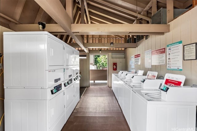 washroom featuring independent washer and dryer, stacked washer / dryer, and wooden walls