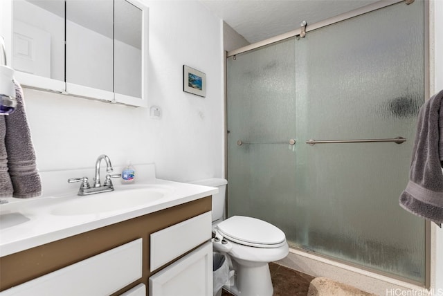 bathroom featuring vanity, walk in shower, toilet, and tile patterned flooring