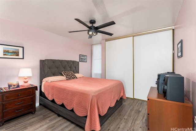 bedroom with a closet, ceiling fan, and light hardwood / wood-style flooring