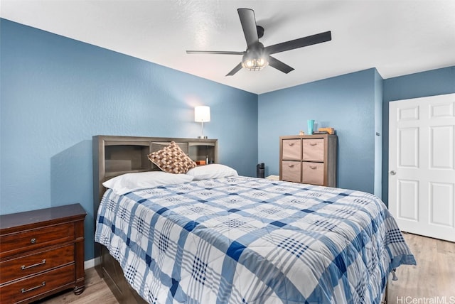 bedroom with light hardwood / wood-style floors and ceiling fan