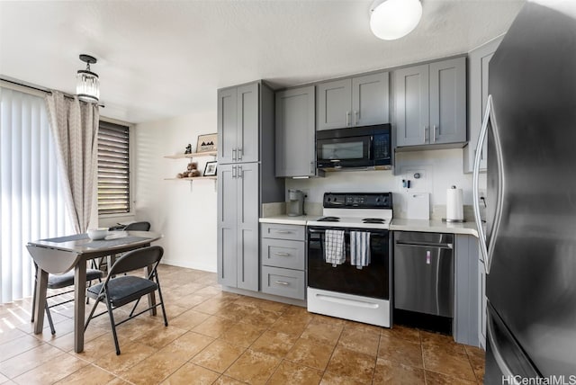 kitchen with gray cabinetry, hanging light fixtures, white range with electric stovetop, and stainless steel fridge