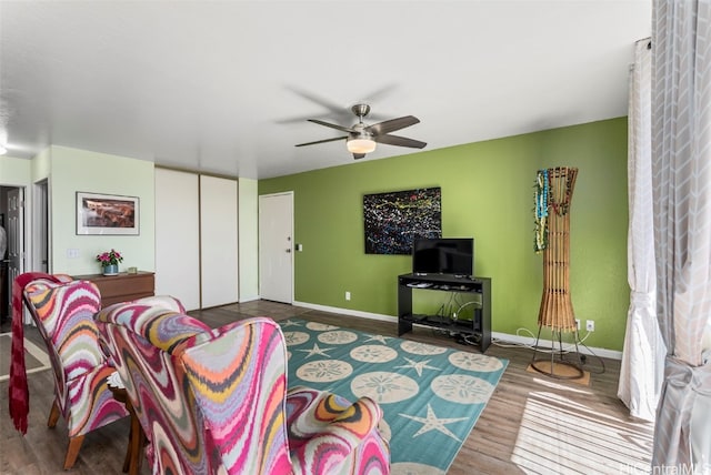 living room with ceiling fan and hardwood / wood-style floors