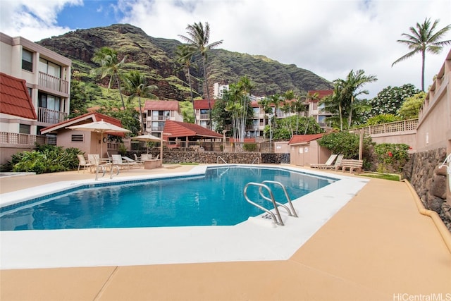 view of pool featuring a patio area and a mountain view