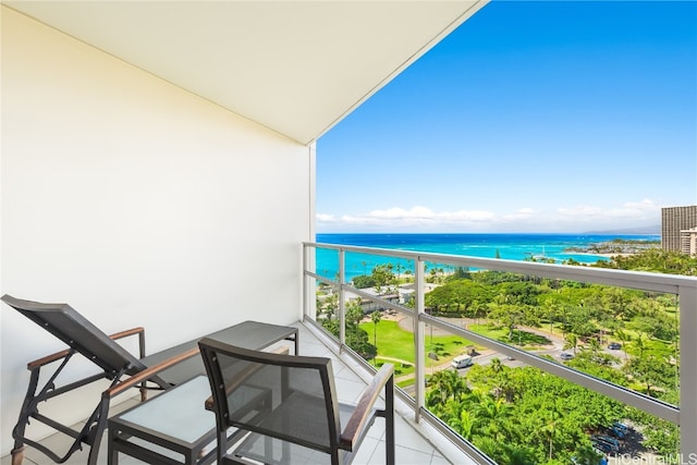 balcony featuring a water view and a view of the beach