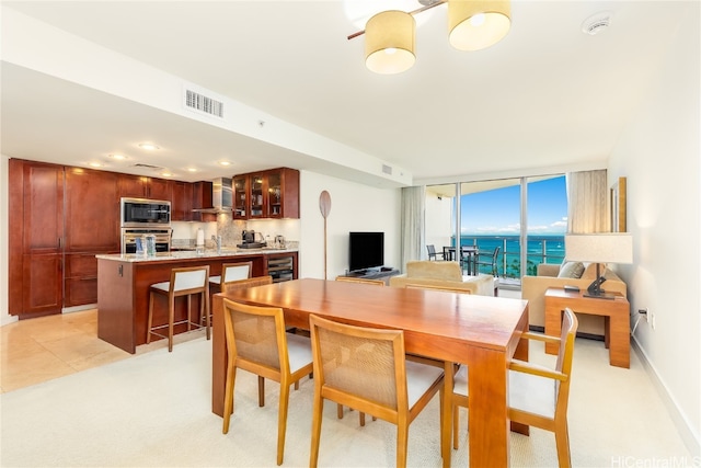 dining area with wine cooler and light tile patterned floors