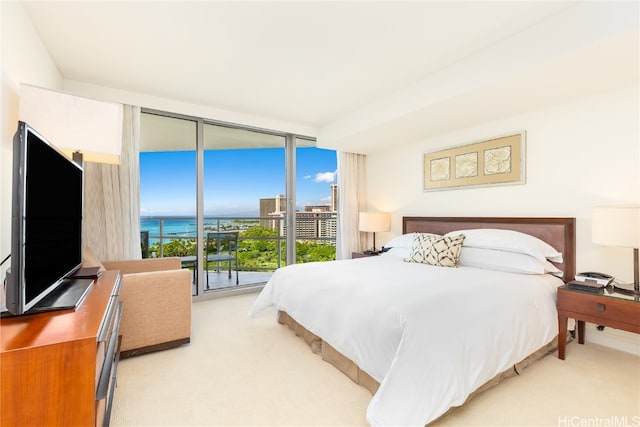 carpeted bedroom featuring a wall of windows and access to exterior