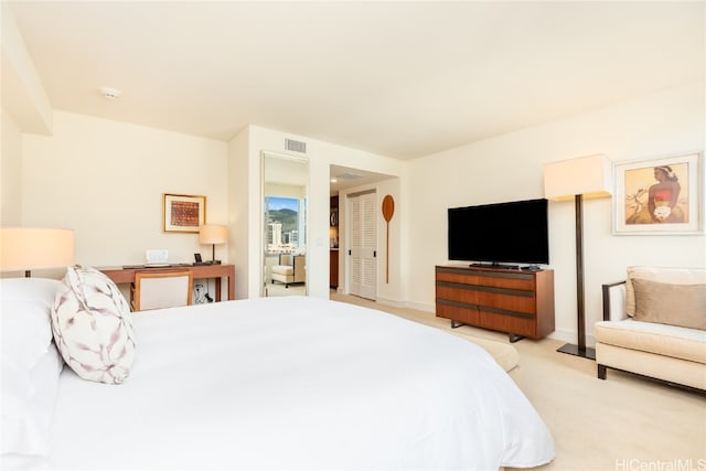 bedroom with light colored carpet