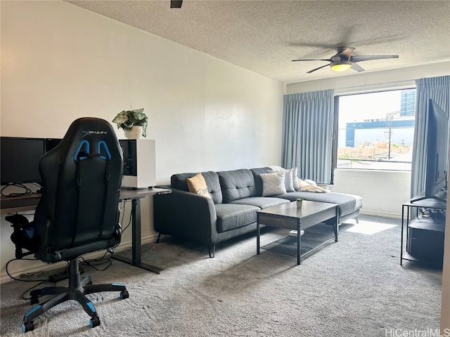 carpeted office with a textured ceiling and ceiling fan