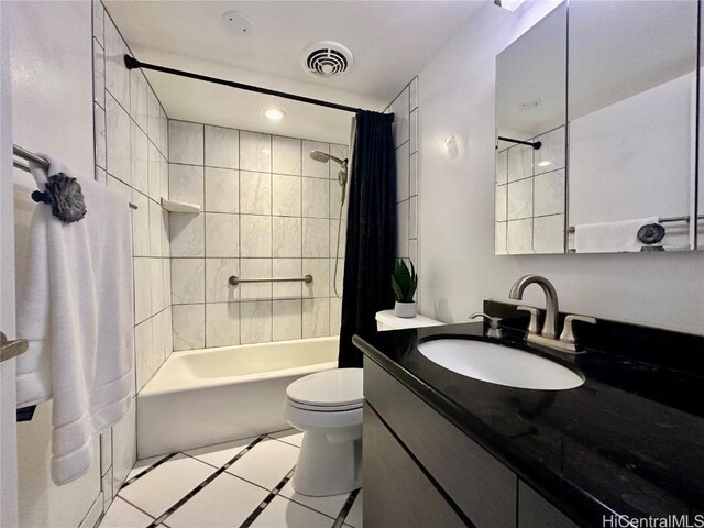 bathroom with vanity, visible vents, shower / bath combo with shower curtain, tile patterned floors, and toilet