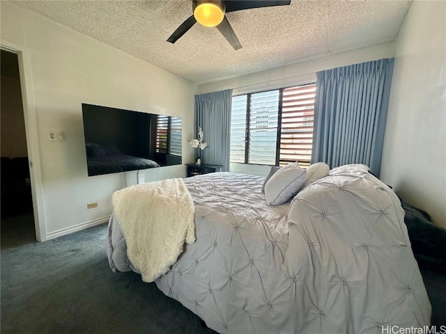 carpeted bedroom featuring baseboards, a textured ceiling, and ceiling fan