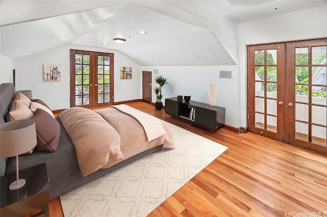 bedroom with french doors, access to outside, and hardwood / wood-style floors