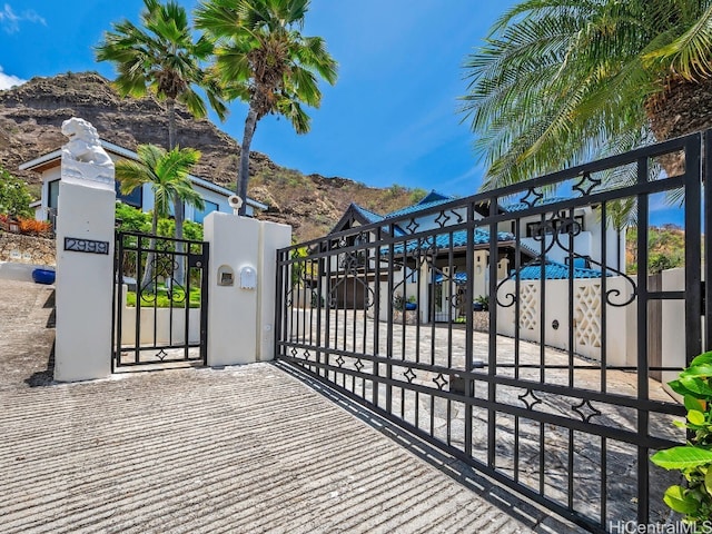 view of gate with a mountain view