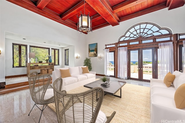 living room with beamed ceiling, french doors, coffered ceiling, and wooden ceiling