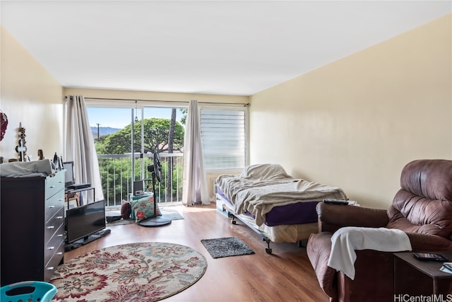 bedroom featuring hardwood / wood-style floors and access to exterior