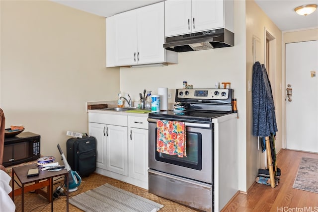 kitchen featuring white cabinetry, sink, light wood-type flooring, and stainless steel range with electric cooktop