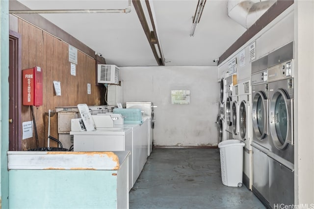 washroom with wooden walls and washer and clothes dryer