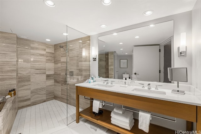 bathroom with vanity and tiled shower