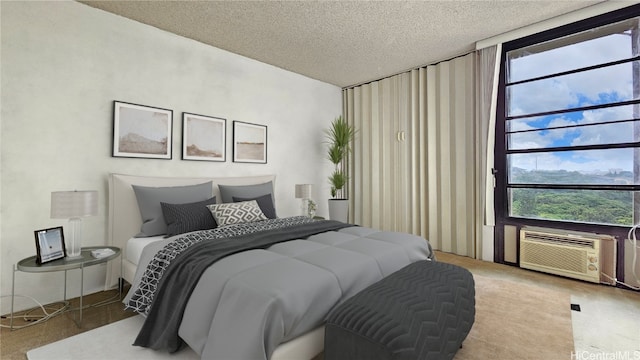 bedroom featuring a wall mounted air conditioner and a textured ceiling