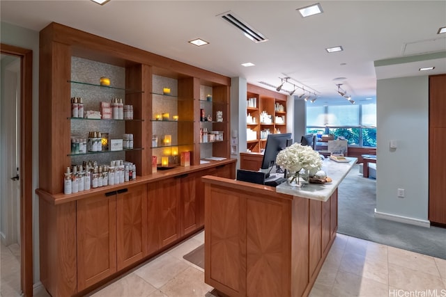 bar featuring track lighting and light tile patterned floors