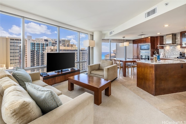 living room featuring floor to ceiling windows, plenty of natural light, and light tile patterned floors