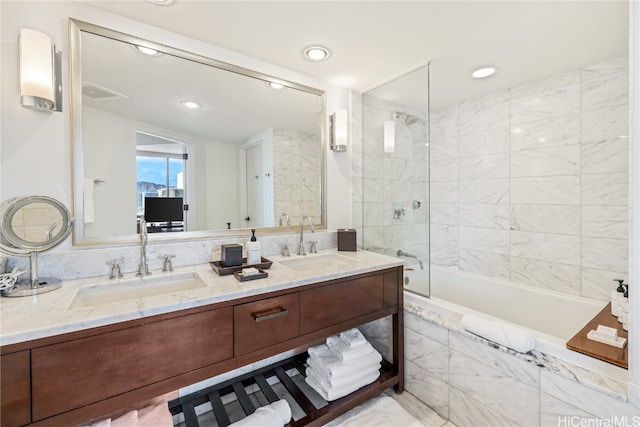 bathroom with vanity and tiled shower / bath