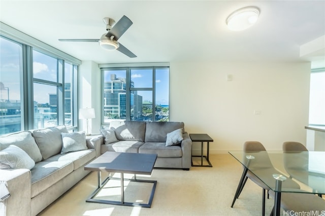 carpeted living room with expansive windows and ceiling fan