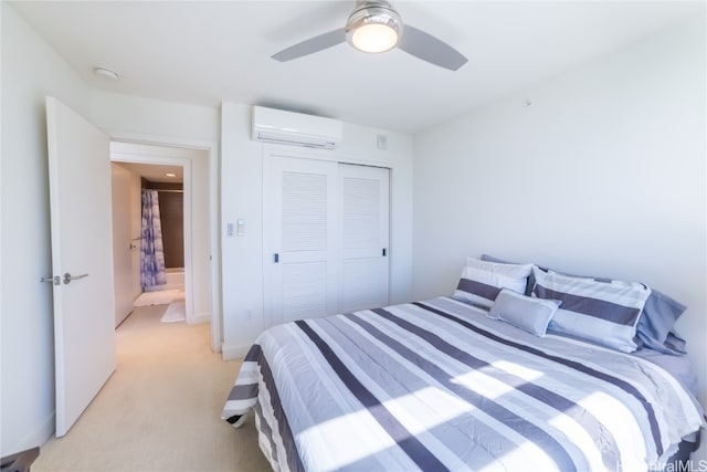 carpeted bedroom with a wall unit AC, a closet, and ceiling fan