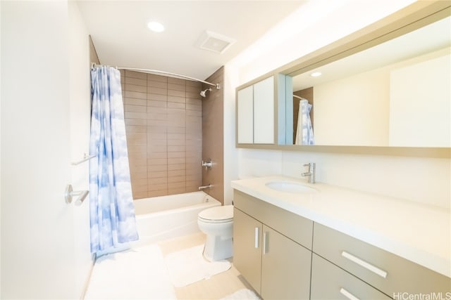 full bathroom with vanity, shower / bath combo with shower curtain, and toilet