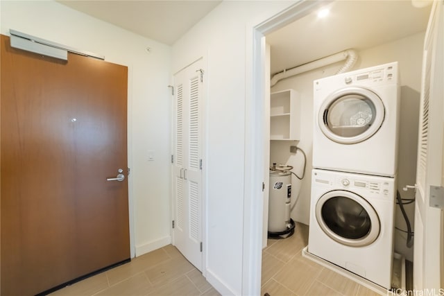 laundry area with stacked washing maching and dryer