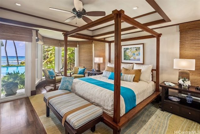 bedroom featuring ceiling fan, a water view, and hardwood / wood-style flooring