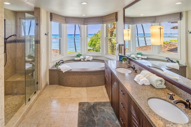 bathroom with vanity, a water view, and separate shower and tub