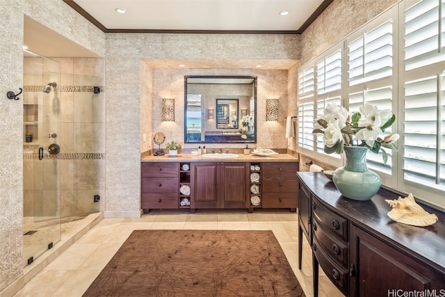 bathroom featuring vanity, tile patterned floors, ornamental molding, and an enclosed shower