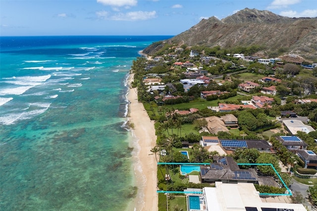 drone / aerial view with a beach view and a water and mountain view