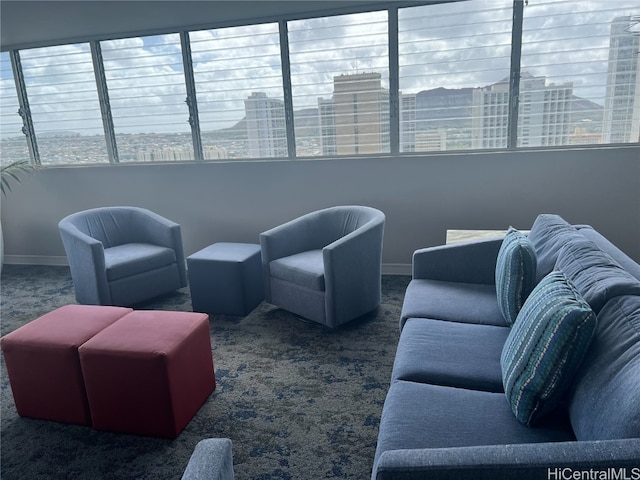 living room featuring dark carpet and plenty of natural light