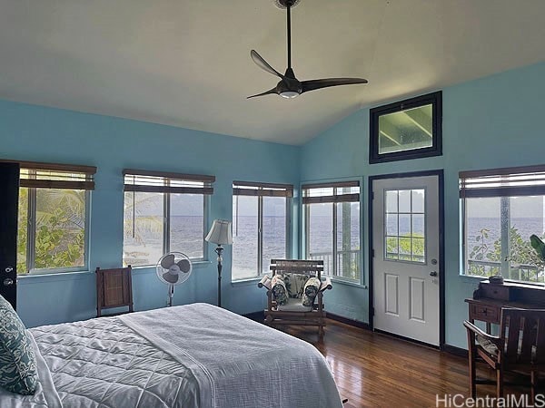 bedroom featuring lofted ceiling, dark wood-type flooring, a water view, and ceiling fan