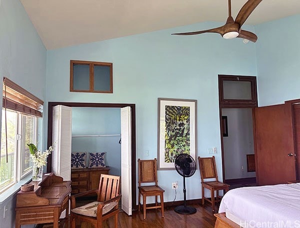 bedroom featuring lofted ceiling, dark wood-type flooring, and ceiling fan