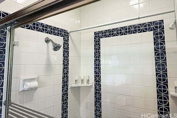 bathroom featuring a shower with door