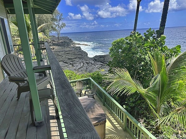 exterior space with a water view and a beach view