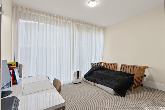 carpeted bedroom with baseboards