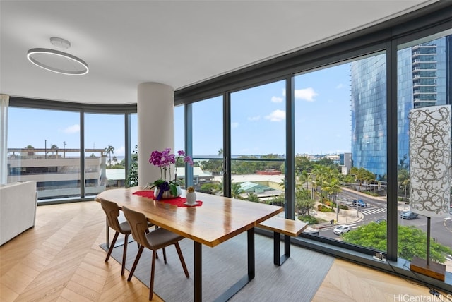 dining room featuring expansive windows, plenty of natural light, and a view of city