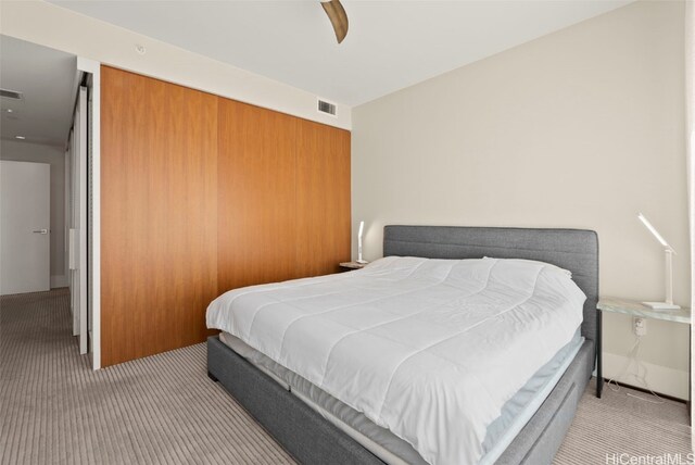 carpeted bedroom featuring visible vents and a ceiling fan