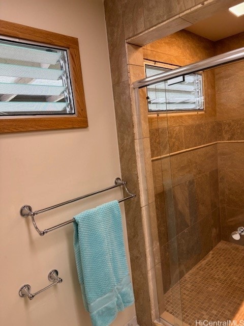 bathroom featuring a shower with shower door