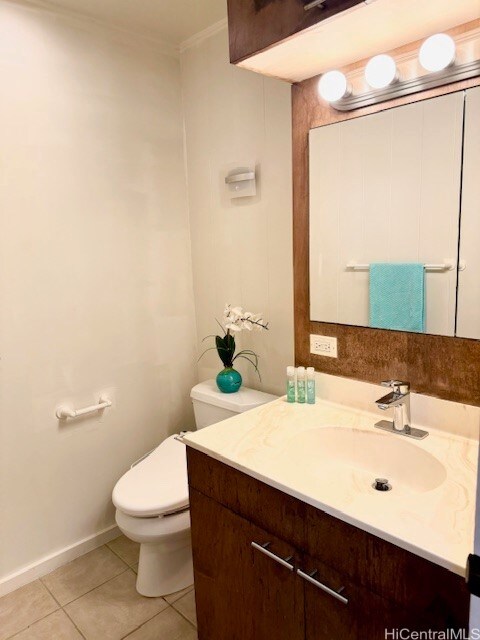 bathroom featuring vanity, crown molding, toilet, and tile patterned floors