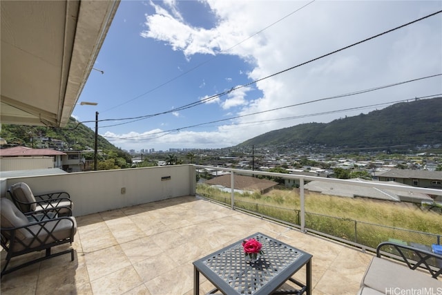 view of patio featuring a mountain view and a balcony